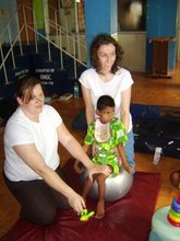 Volunteers from Greenisland helping care for a disabled child in the orphanage.